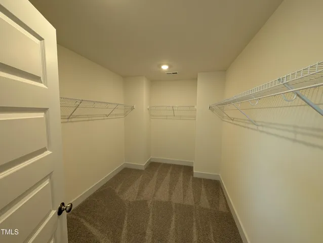 a view of a room with wooden floor and wardrobe