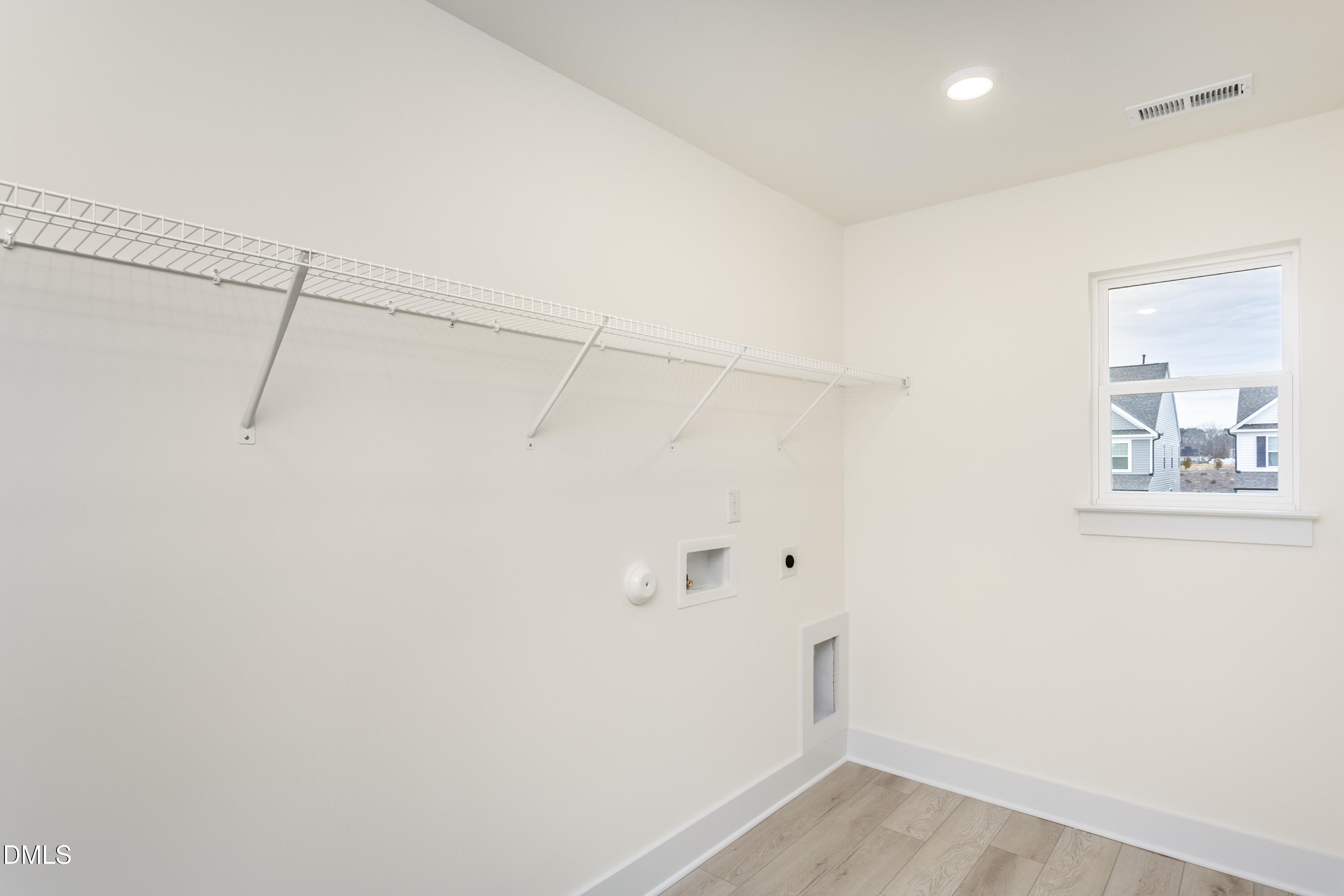 143 Steppe Way Garner, NC 27529 - Photo 29 of 38 a view of a room with racks on the wall