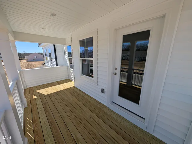a view of a balcony with wooden floor