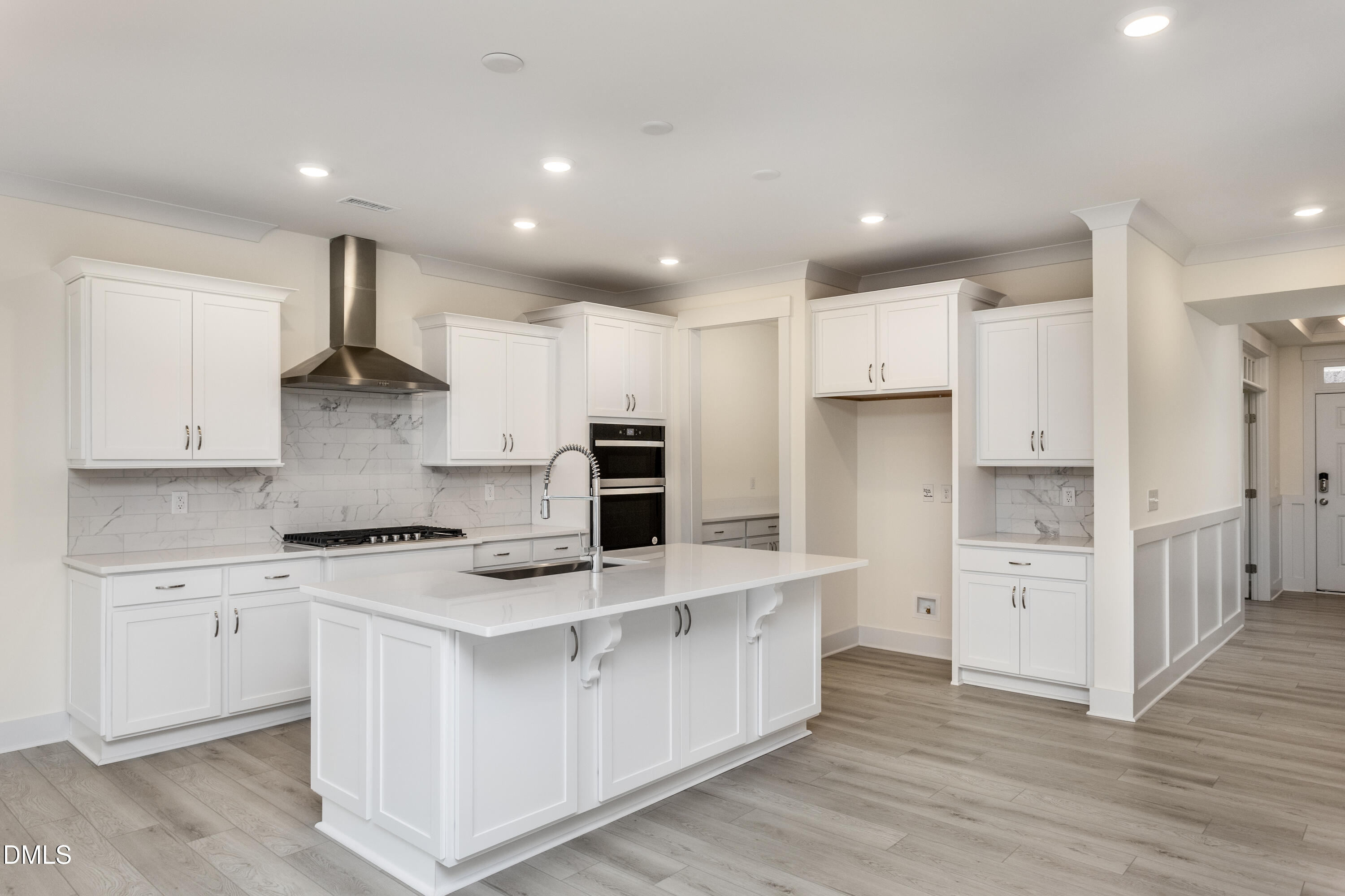 143 Steppe Way Garner, NC 27529 - Photo 9 of 38 a large kitchen with stainless steel appliances granite countertop a stove a sink a refrigerator and white cabinets with wooden floor