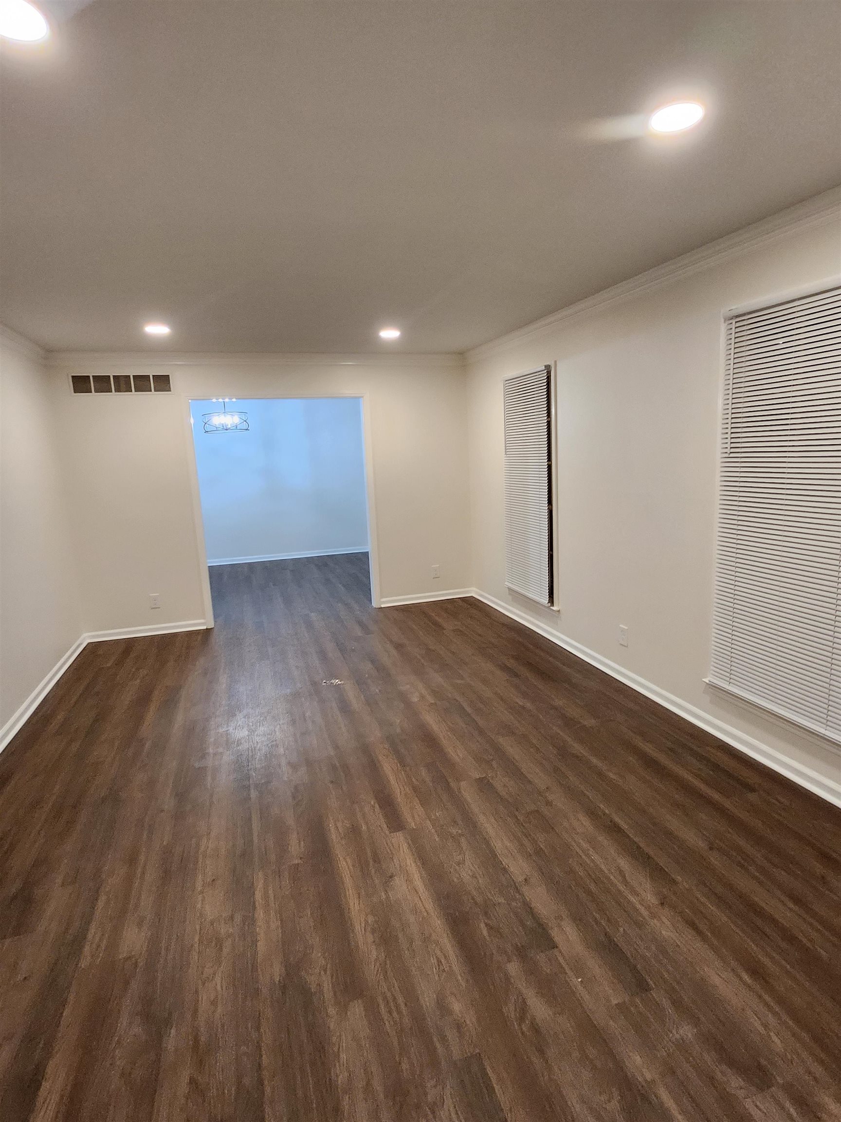5094 Pilgrim Road Memphis, TN 38116 - Photo 4 of 27 an empty room with wooden floor and windows