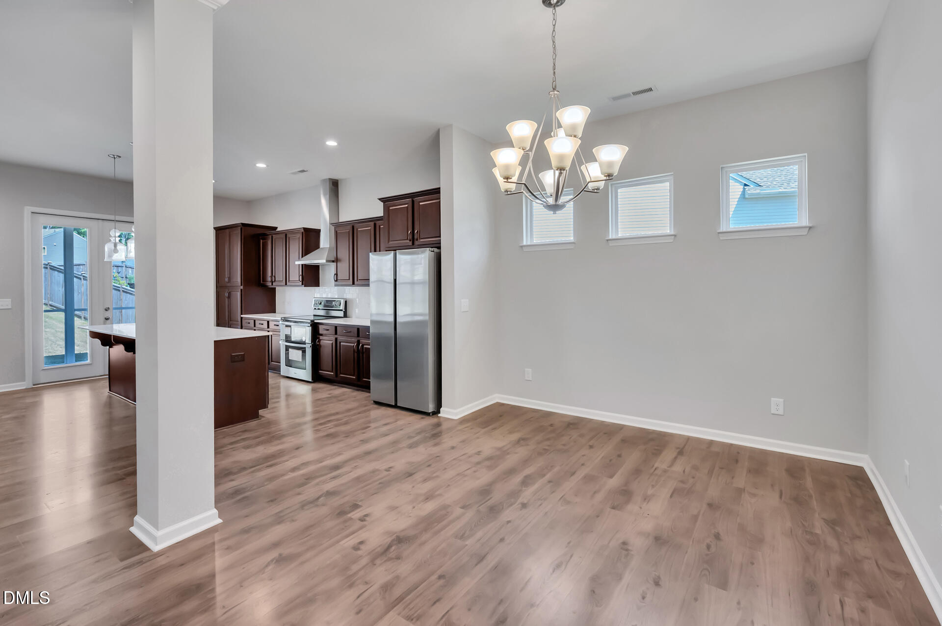5406 Ripplebrook Drive Durham, NC 27712 - Photo 7 of 37 a view of a kitchen with refrigerator and wooden floor