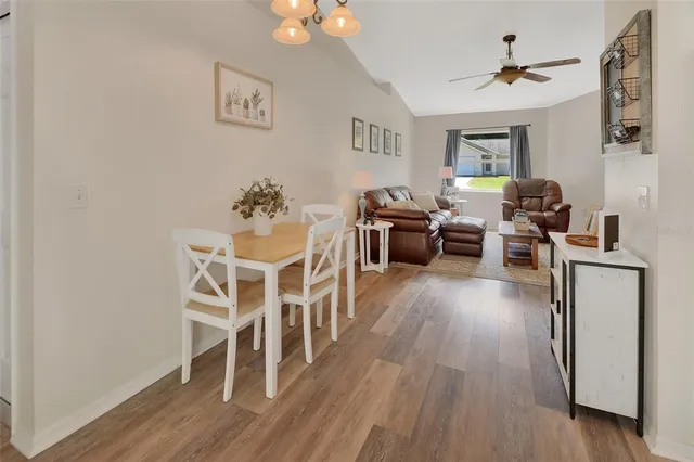 a living room with furniture dining table and wooden floor