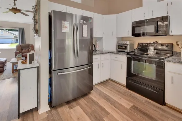 a kitchen with stainless steel appliances a refrigerator stove and microwave