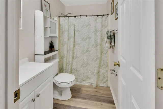 a bathroom with a toilet and a shower