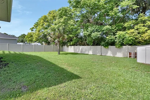 a view of garden with a house in the background