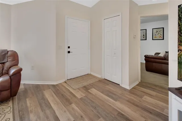 a view of a livingroom with wooden floor and furniture