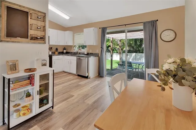 a view of kitchen with furniture and wooden floor
