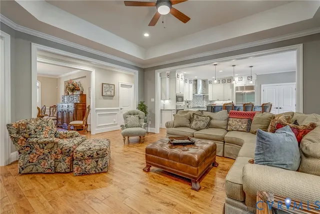 a living room with furniture and a chandelier