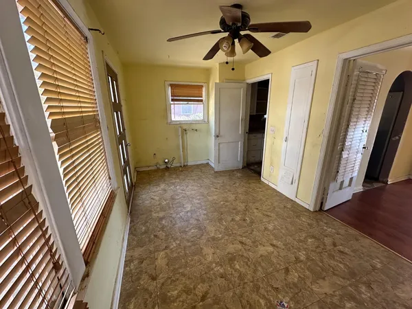 a view of room with stairs and a ceiling fan