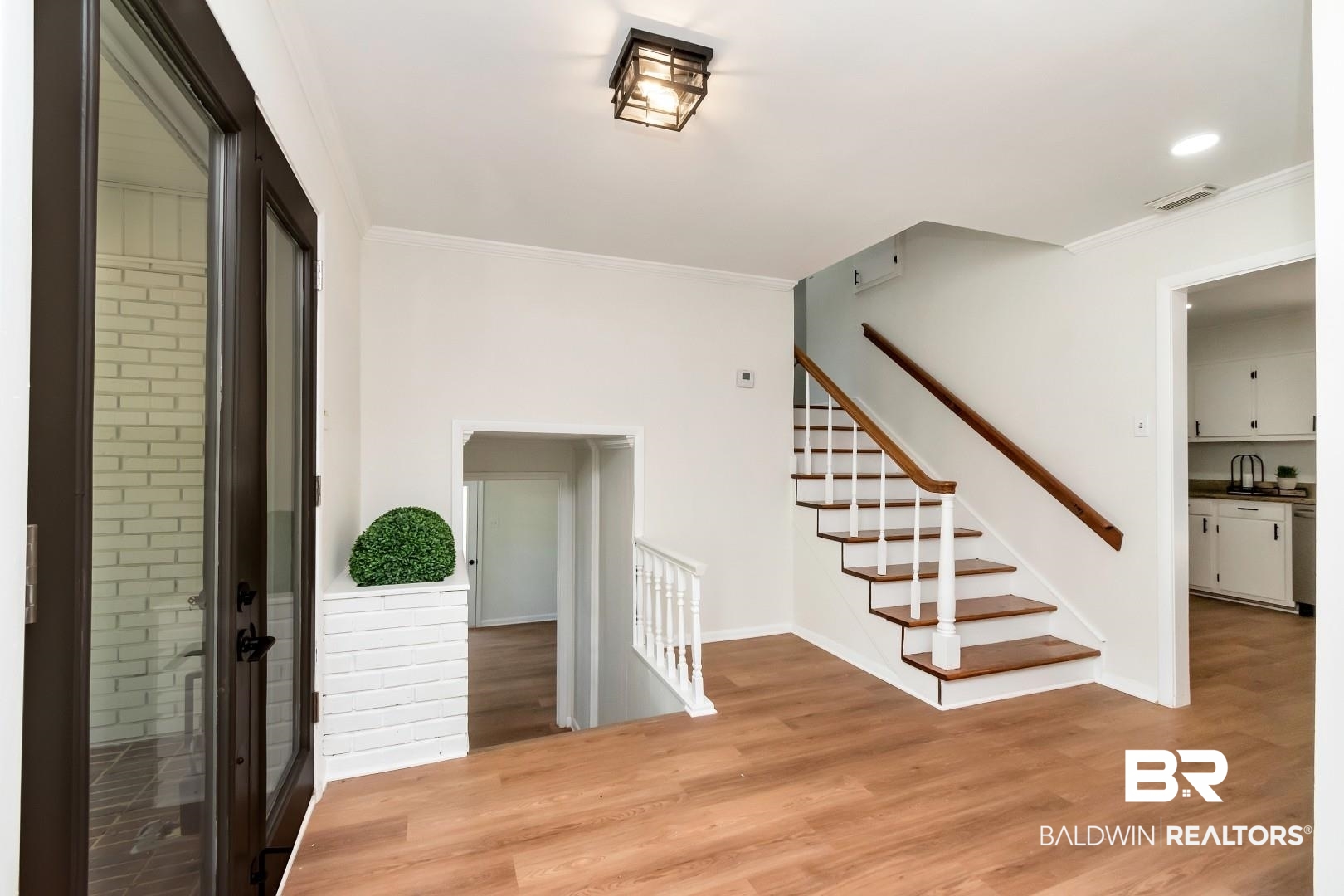 115 Pineridge Road Daphne, AL 36526 - Photo 5 of 34 Entrance foyer with baseboards, visible vents, light wood-style floors, and ornamental molding