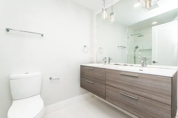 a bathroom with a toilet a sink and mirror