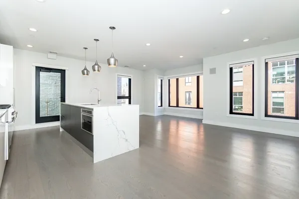 an open kitchen with a sink and dish washer