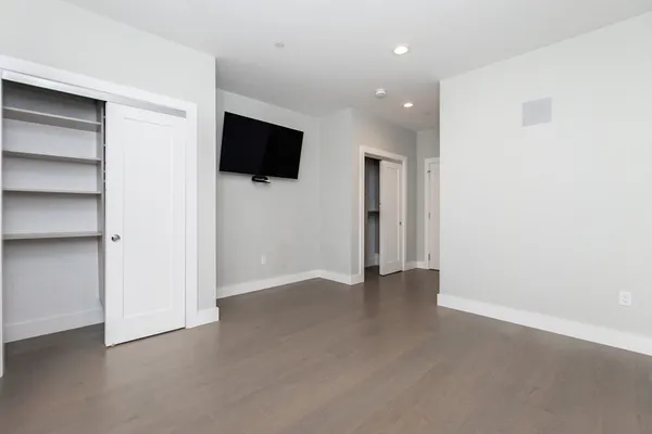a view of an empty room with a kitchen