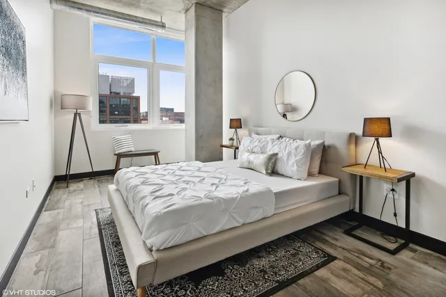 a bedroom with a large bed and a window