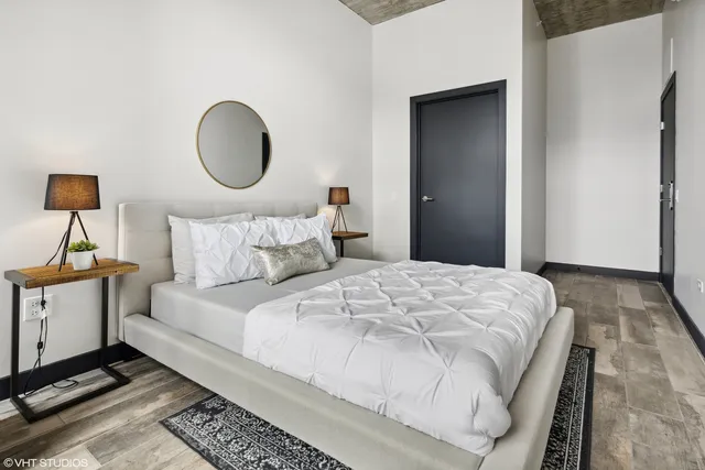 a bedroom with a bed and a lamp