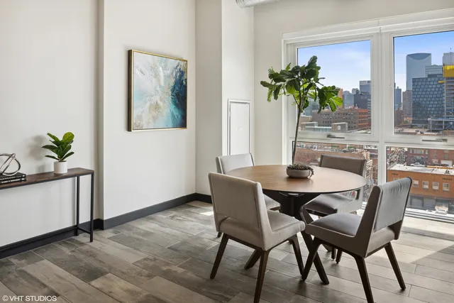 a dining room with furniture and potted plant