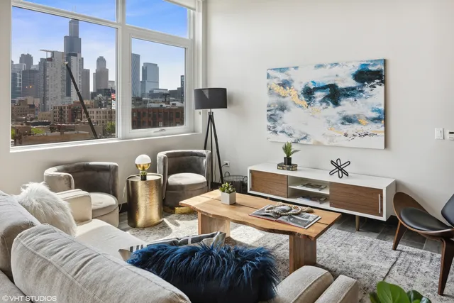 a living room with furniture and a floor to ceiling window