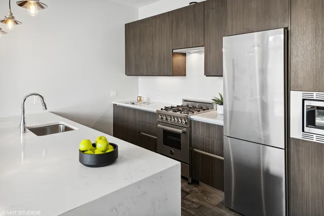 a kitchen with a sink and stainless steel appliances