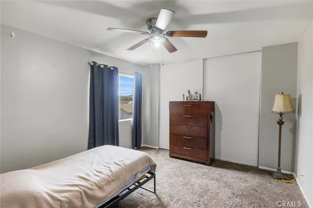 a bedroom with a bed and a dresser