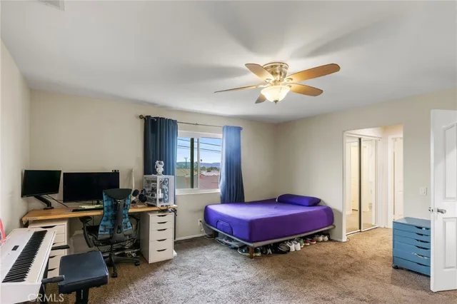 a bedroom with a bed and a desk