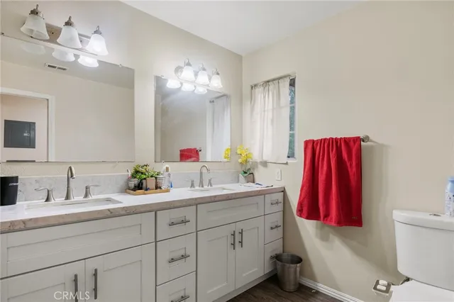 a bathroom with a double vanity sink and a mirror