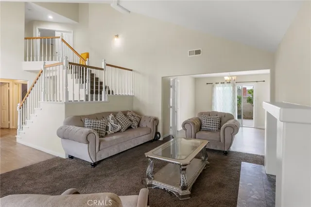 a living room with furniture ceiling fan and a rug