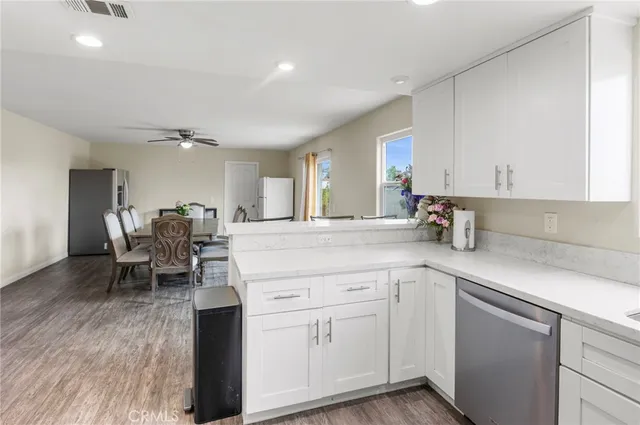 a kitchen with white cabinets and sink