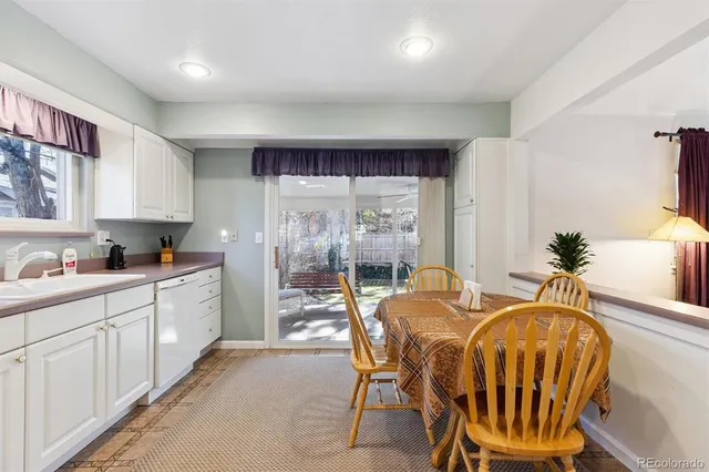 a kitchen with a table chairs and a refrigerator
