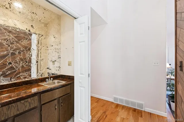 a bathroom with a granite countertop sink and a mirror