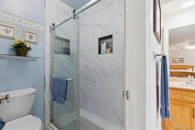 a bathroom with a toilet and a shower