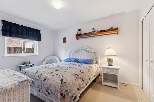 a bedroom with a bed and a night stand