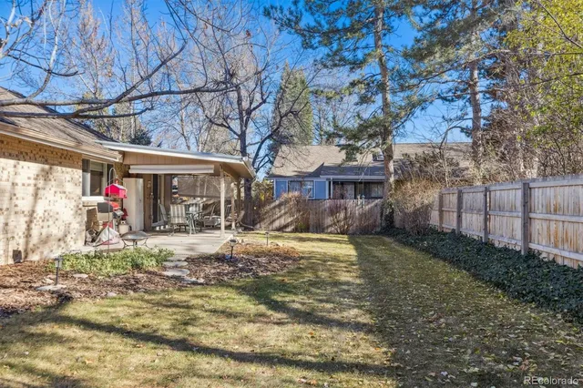 a view of a house with a small yard and tree s