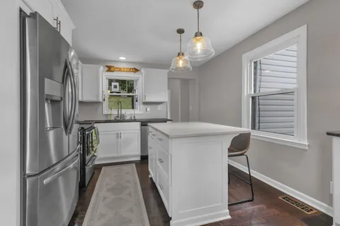 a kitchen with stainless steel appliances a refrigerator and a stove top oven