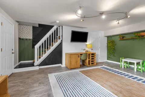 a bedroom with furniture and a flat screen tv