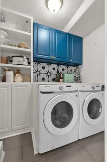 a utility room with sink dryer and washer