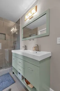 a bathroom with a sink mirror and vanity