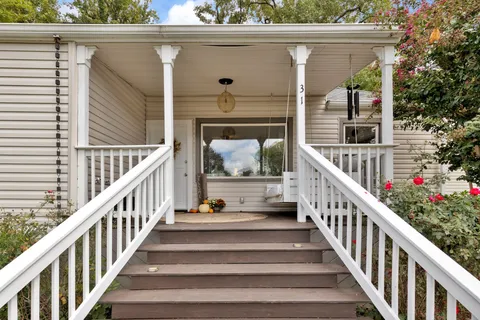 a view of balcony with wooden floor and stairs
