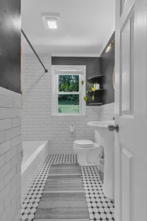 a bathroom with a sink a toilet and a mirror