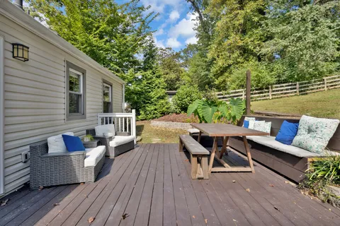 a house view with swimming pool and wooden fence