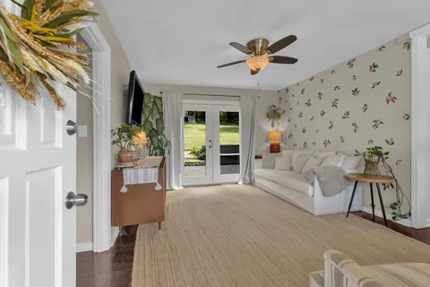 a living room with furniture and a chandelier
