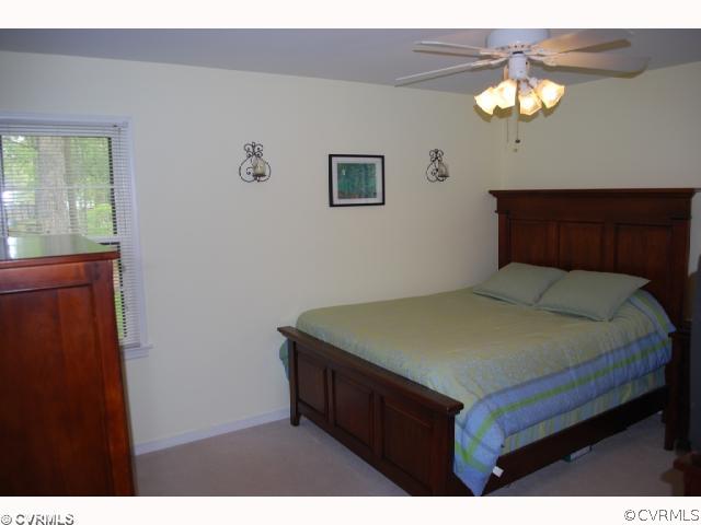 11121 Alanthus Road Midlothian, VA 23112 - Photo 5 of 12 a bedroom with a bed and a chandelier
