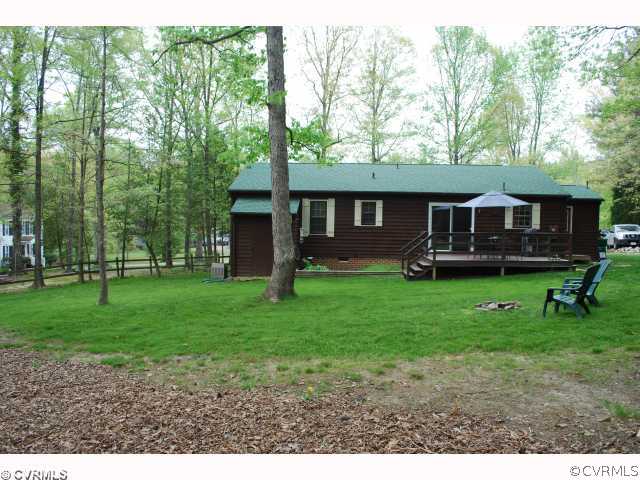 11121 Alanthus Road Midlothian, VA 23112 - Photo 10 of 12 a view of a house with a backyard and a patio