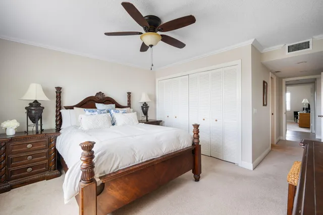 a bed room with a bed and a ceiling fan