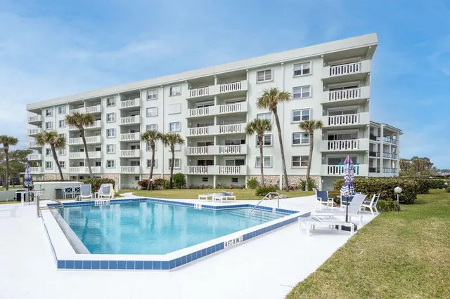 a view of swimming pool with outdoor seating