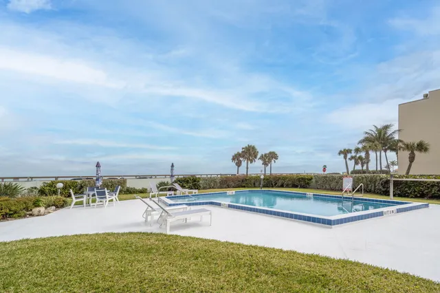 a view of a swimming pool with an ocean view