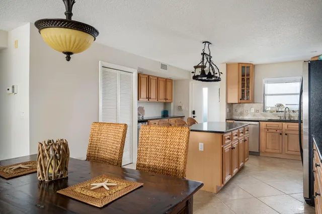 a kitchen with sink and refrigerator
