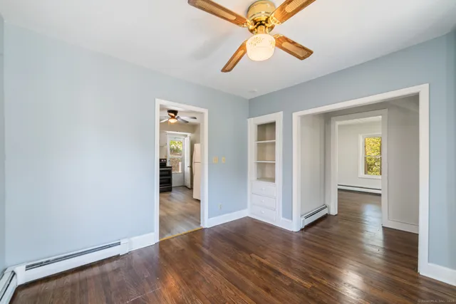 wooden floor in an empty room with a window