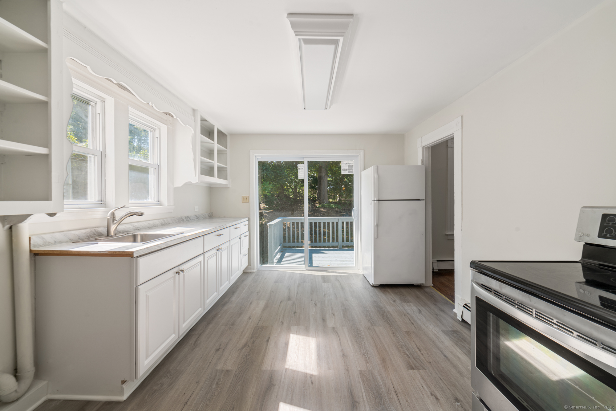 23 Salem Street Naugatuck, CT 06770 - Photo 18 of 40 a large kitchen with a lot of white cabinets and wooden floor