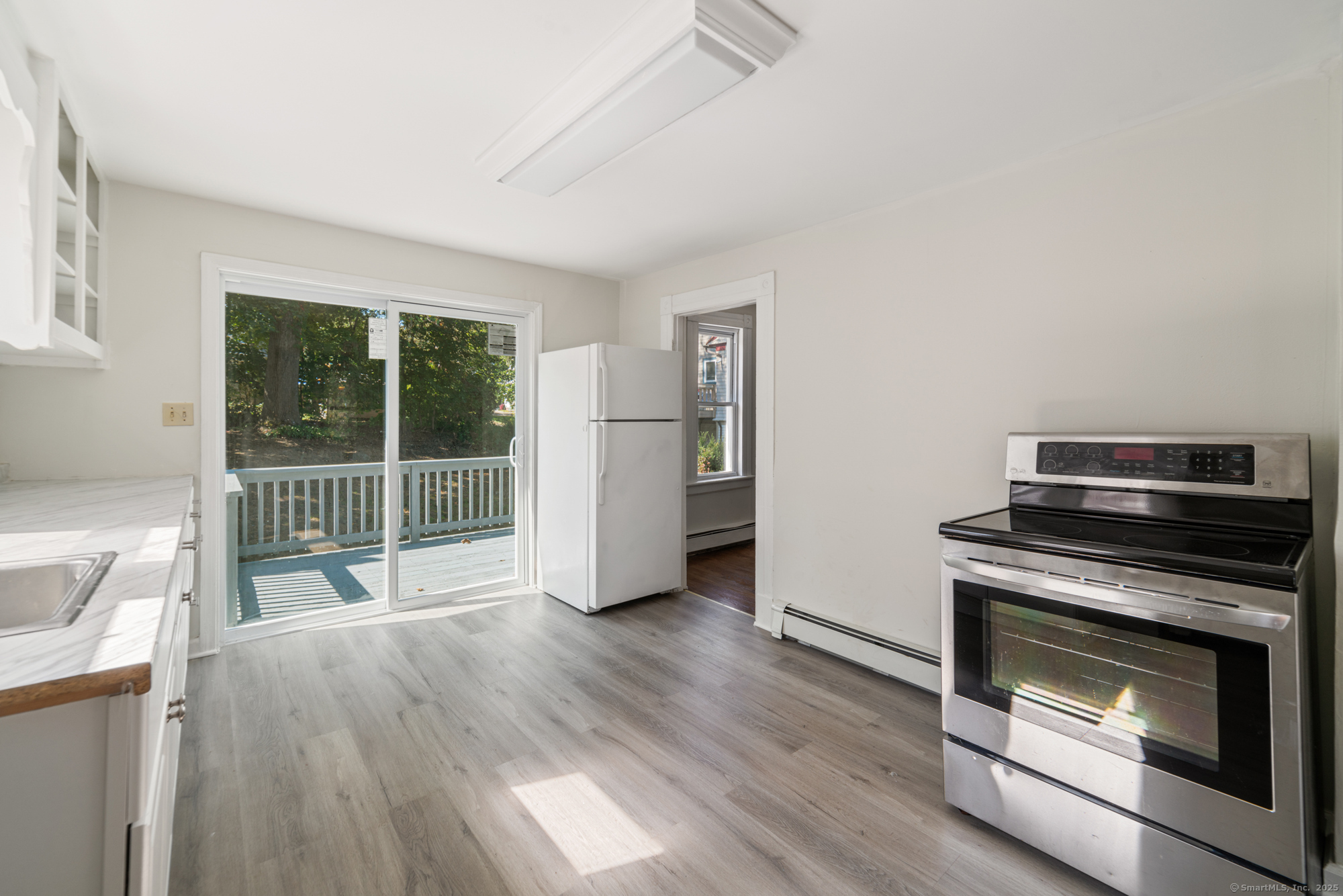 23 Salem Street Naugatuck, CT 06770 - Photo 19 of 40 a kitchen with wooden floors and a fireplace